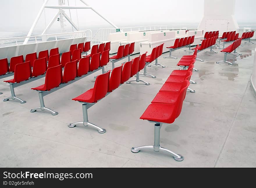 Wet red modern chairs outside