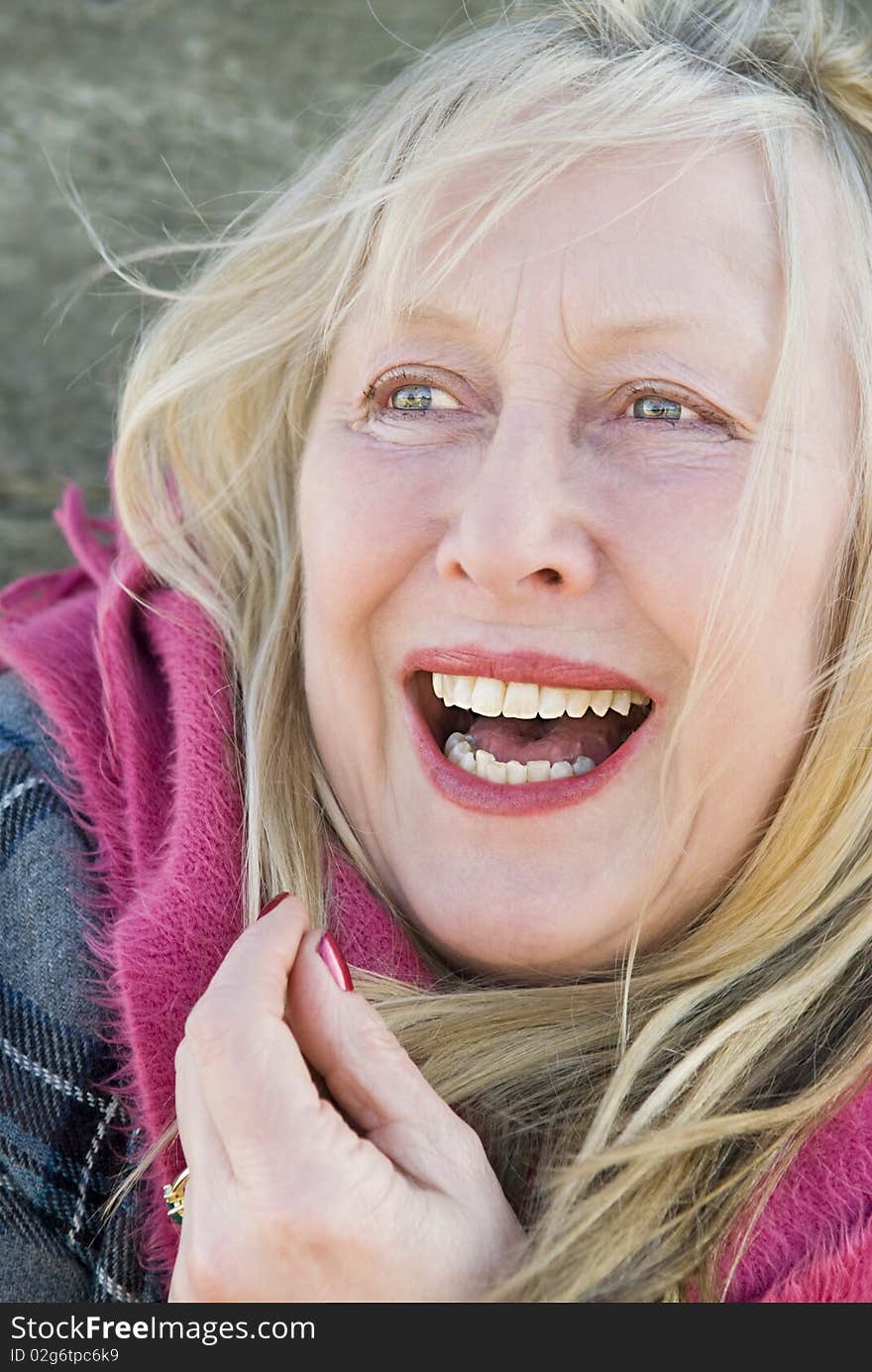 A colour portrait photo of a beautiful happy smiling woman in her sixties. A colour portrait photo of a beautiful happy smiling woman in her sixties.