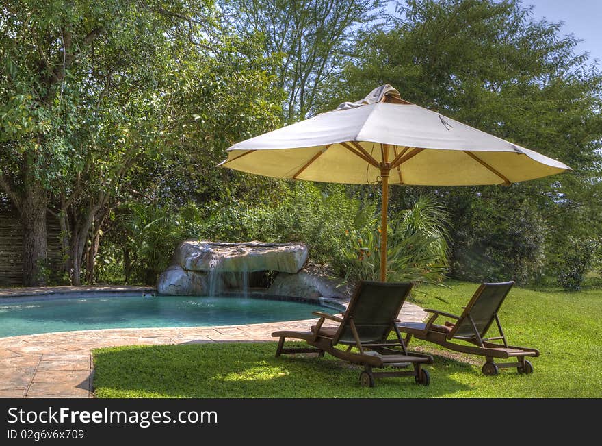 HDR image of a tranquil poolside scene. Perfect for holiday and vacation concepts. HDR image of a tranquil poolside scene. Perfect for holiday and vacation concepts.