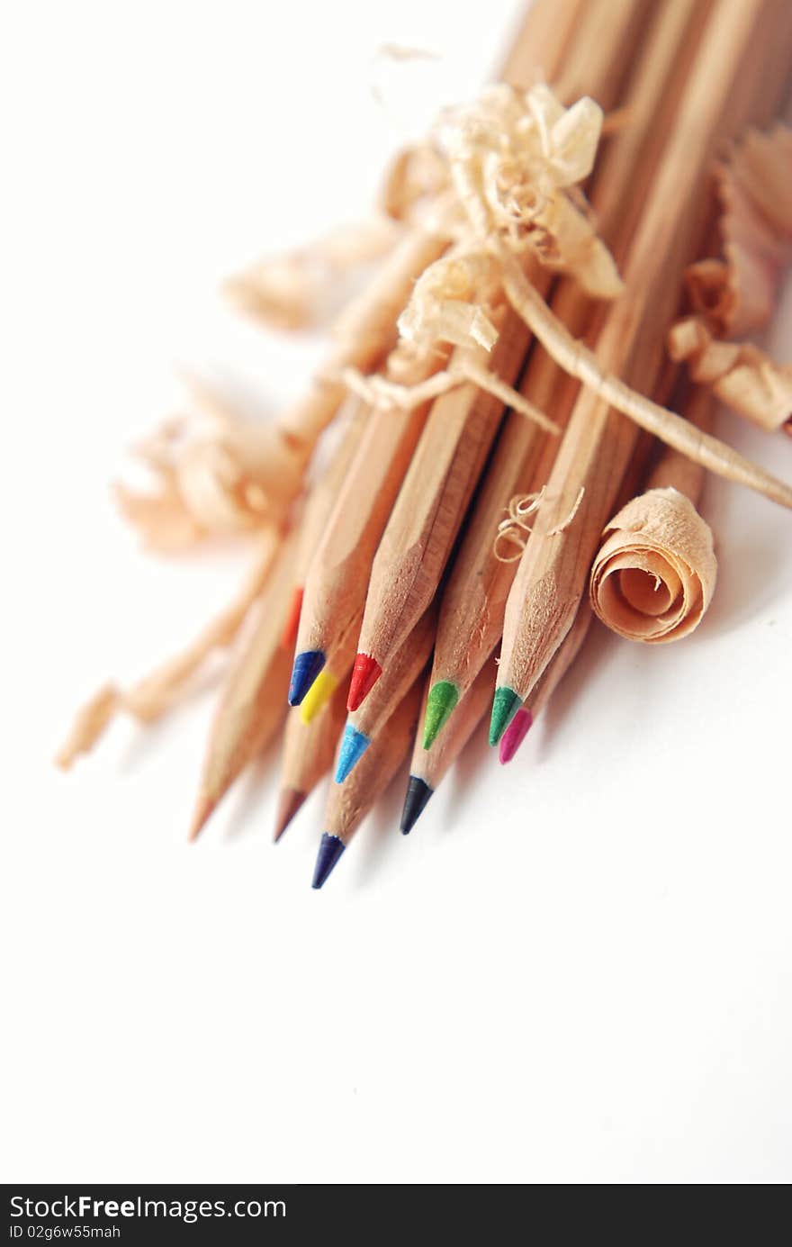 Coloured pencils with shavings isolated on a white background