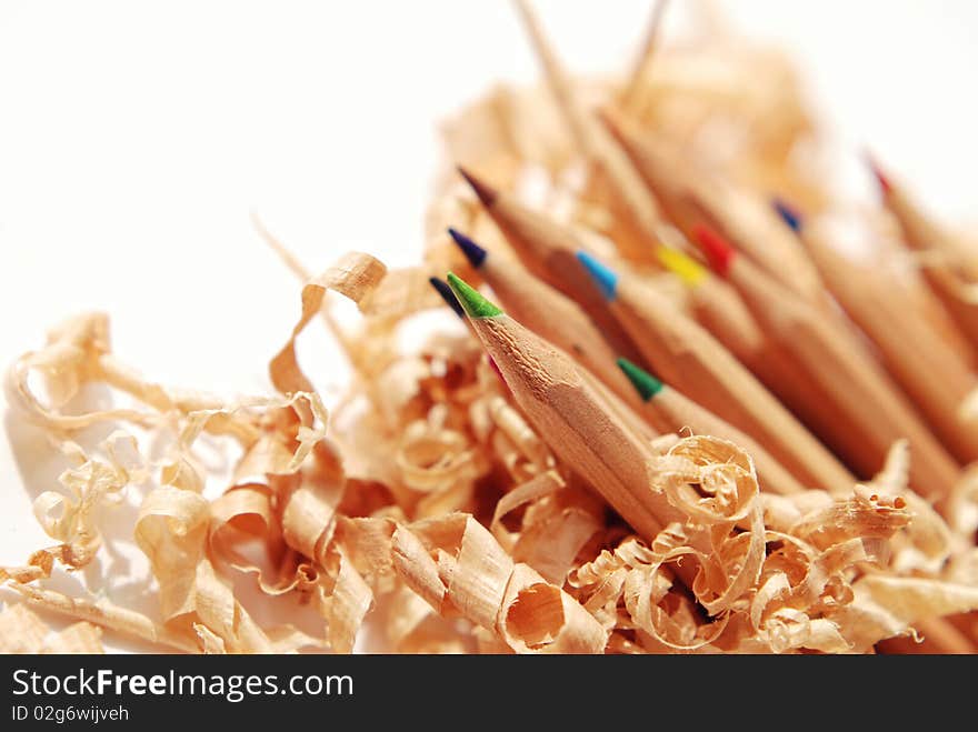 Coloured pencils with shavings isolated on a white background