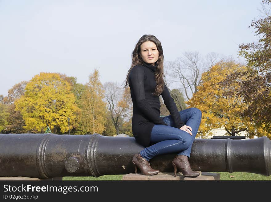 The young woman on walk in autumn park