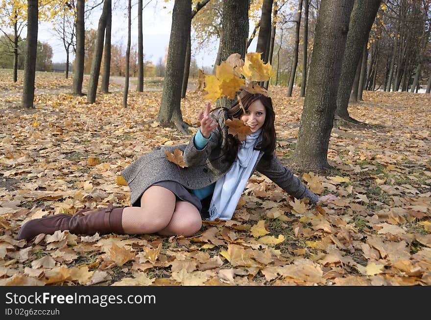 The young woman on walk in autumn park