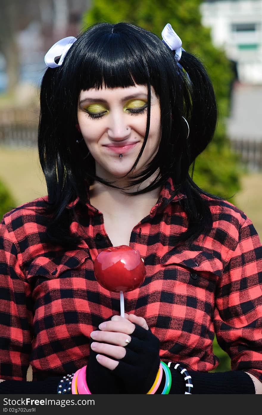 The Girl In A Red Shirt Holds A Red Apple