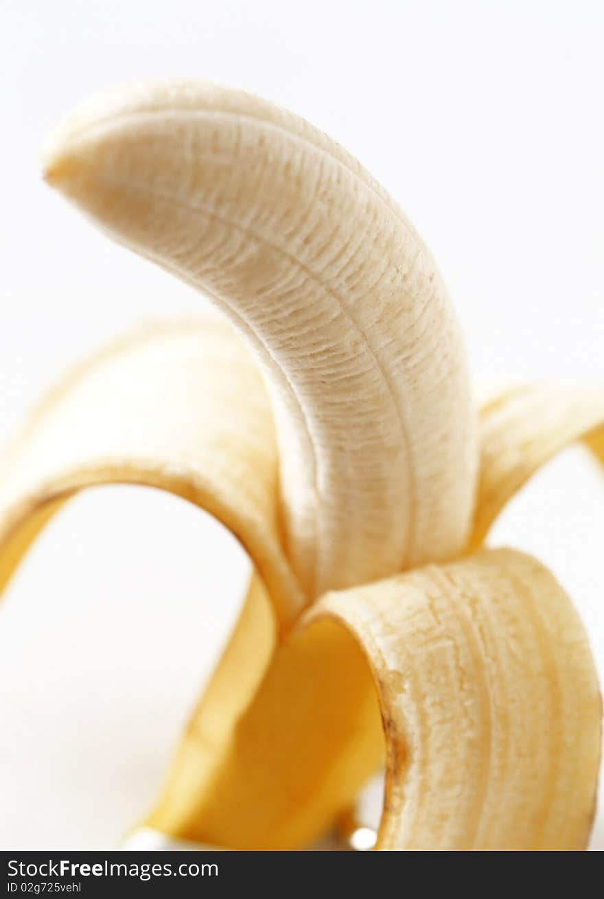 Peeled banana on a white background