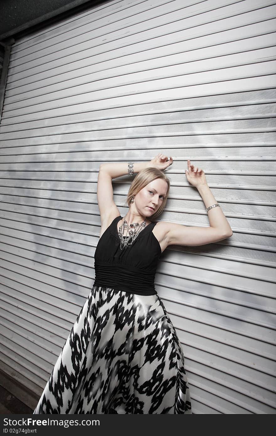 Attractive young fashion model posing in an urban setting. Attractive young fashion model posing in an urban setting