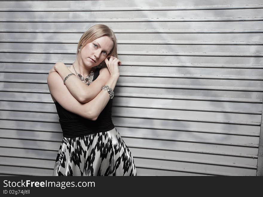 Young Woman Posing On A Metallic Background