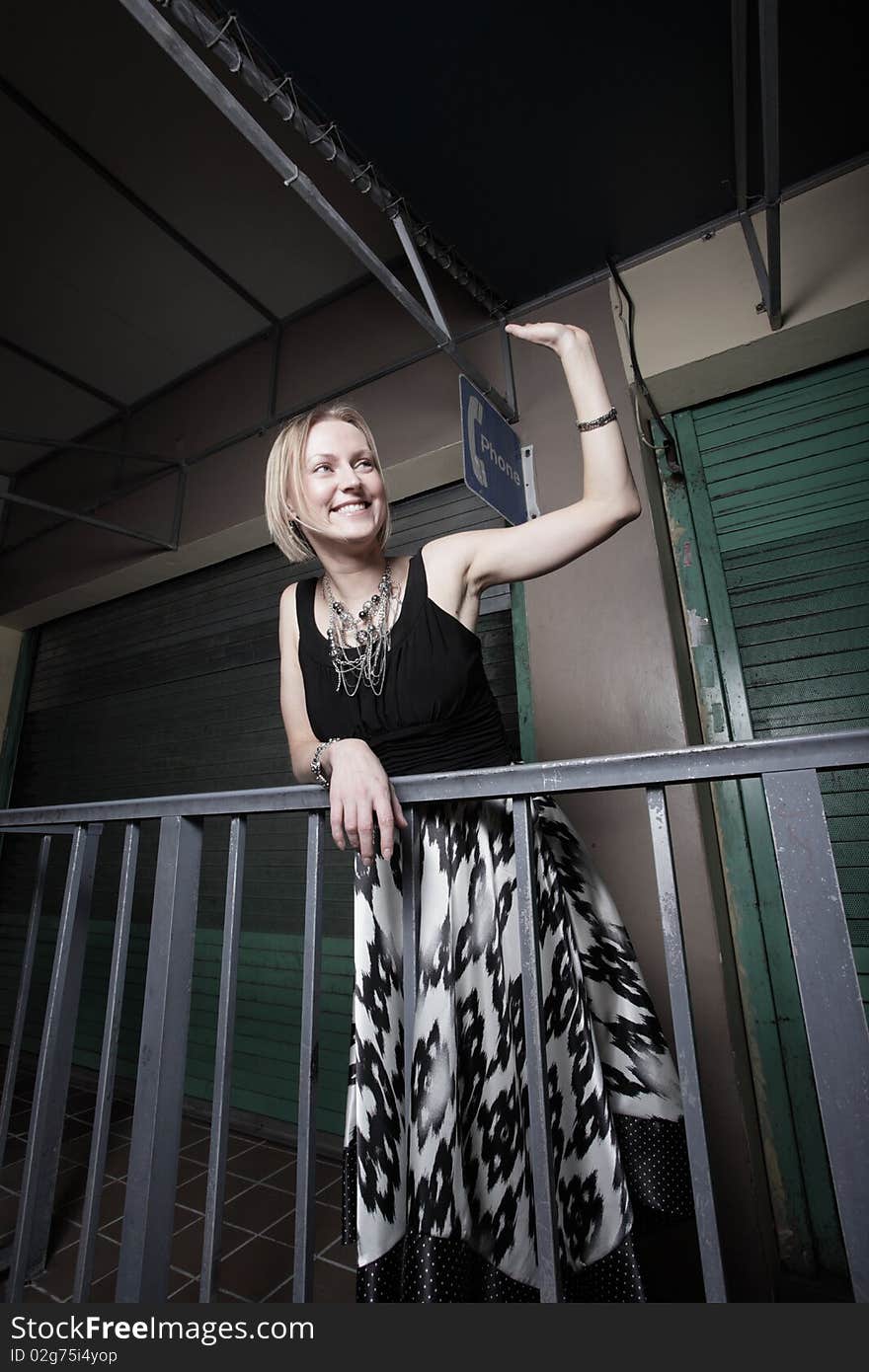 Attractive woman waving at night. Attractive woman waving at night