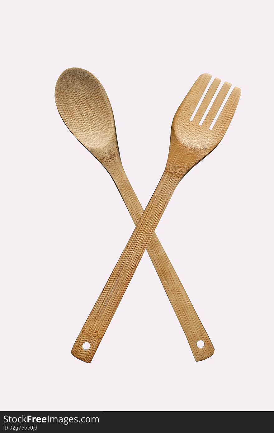 Wooden fork and spoon on a white background. Wooden fork and spoon on a white background