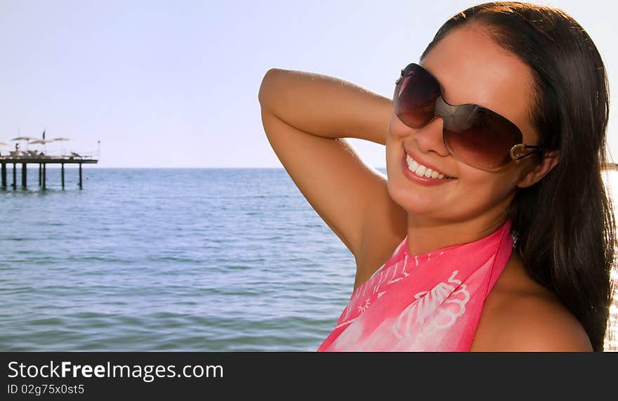 Young beautiful woman at the beach. Young beautiful woman at the beach