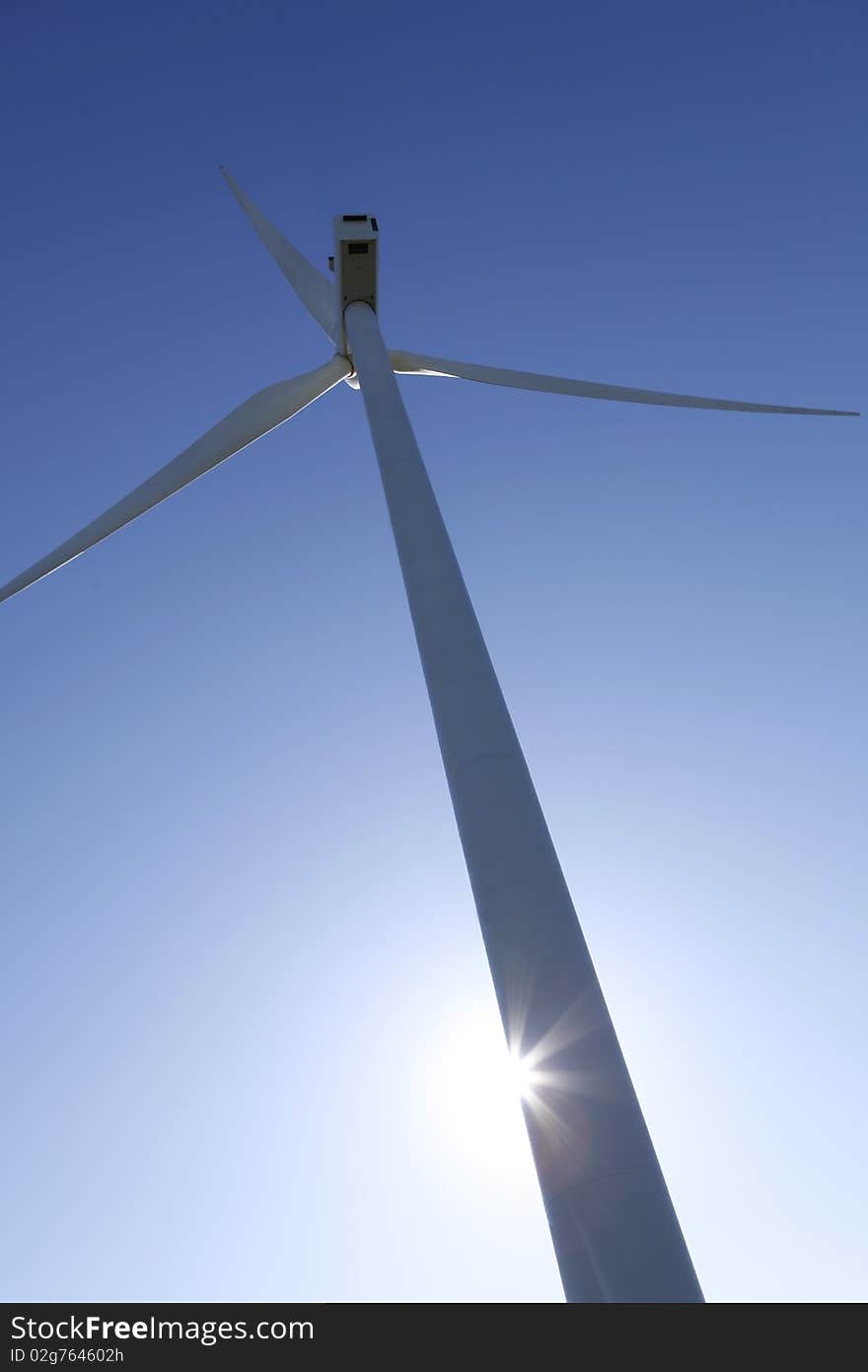 A wind turbine against a clear blue sky. Great for energy and environment themes. A wind turbine against a clear blue sky. Great for energy and environment themes.