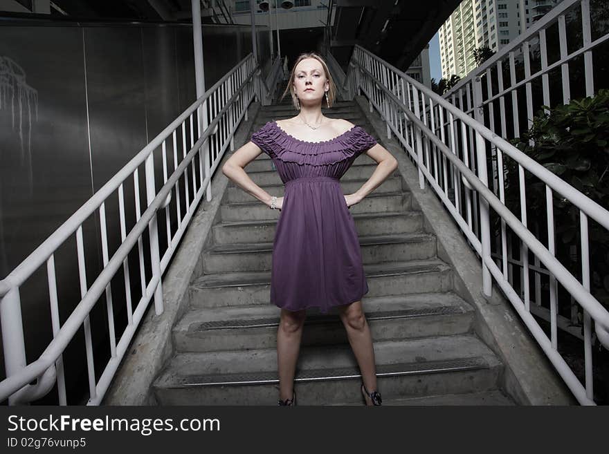 Woman Posing By A Staircase