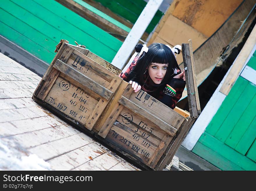 The beautiful girl gets out of the shipping container. The beautiful girl gets out of the shipping container