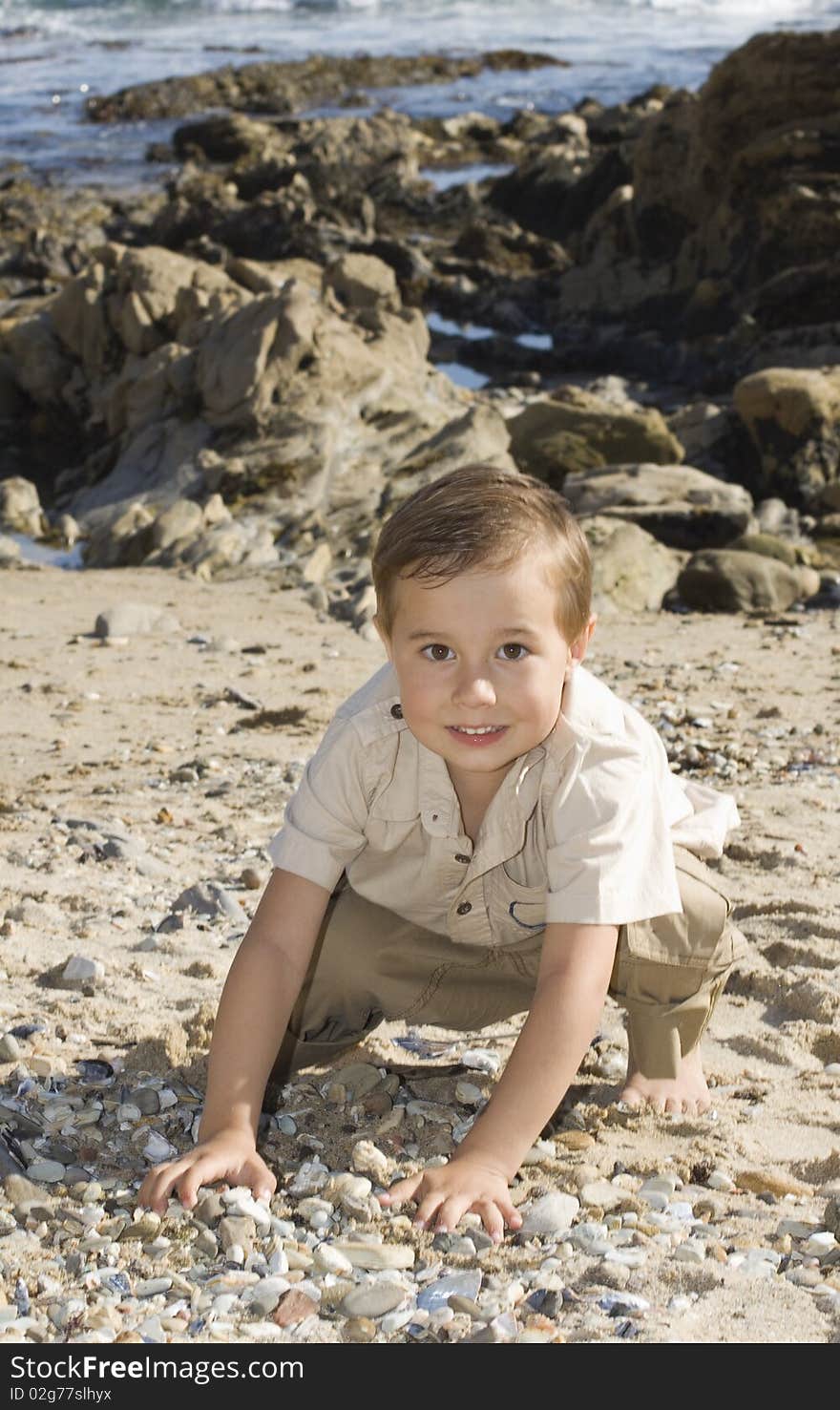 Boy is playing at the beach with stones. Boy is playing at the beach with stones