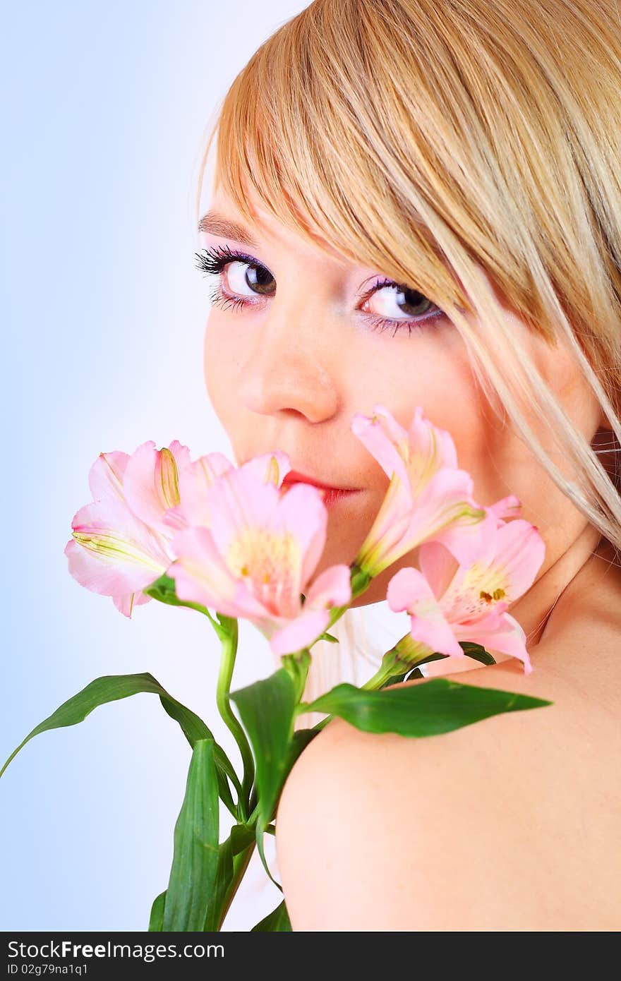 Portrait of a woman holding pink flowers over white background