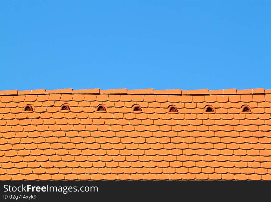 A roof top with blue sky behind it. A roof top with blue sky behind it