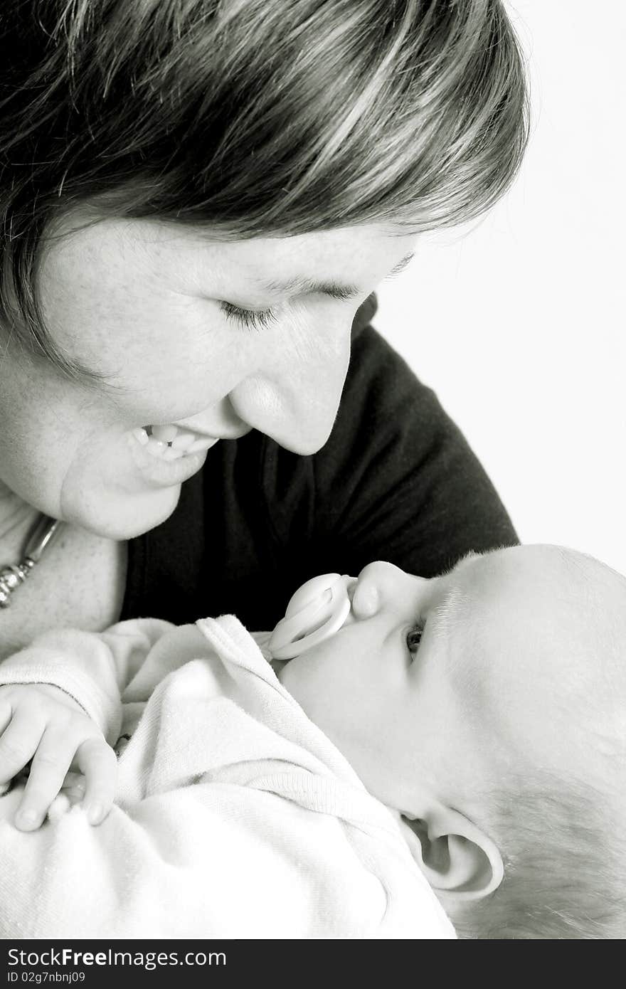 Smiling new mother holding her son in her arms. Smiling new mother holding her son in her arms