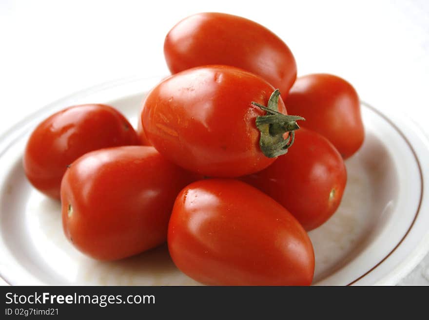 Tomatoes on the plate in isolated on white