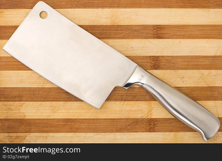 Meat cleaver isolated over wooden background