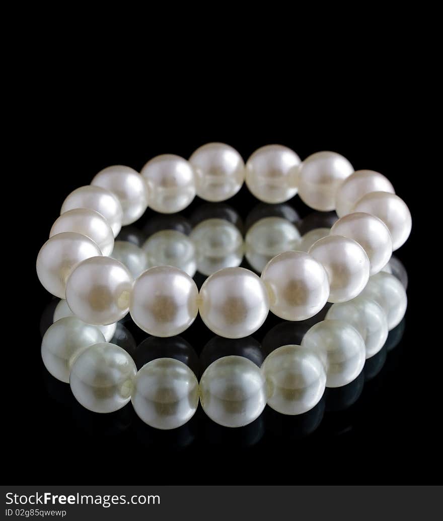 White isolated beads over black background