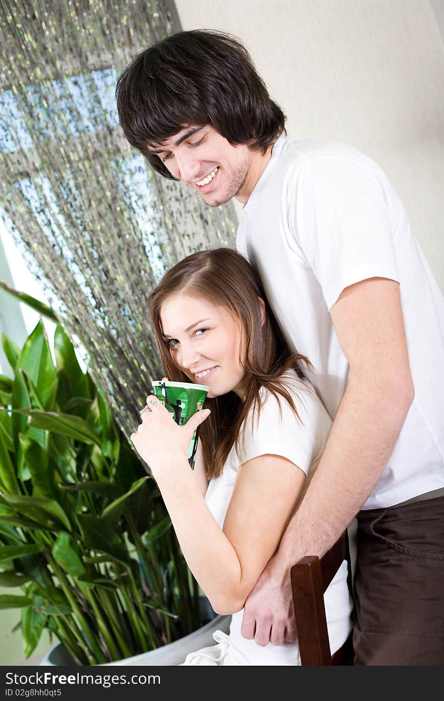 Girl With Cup On Chair And Boy