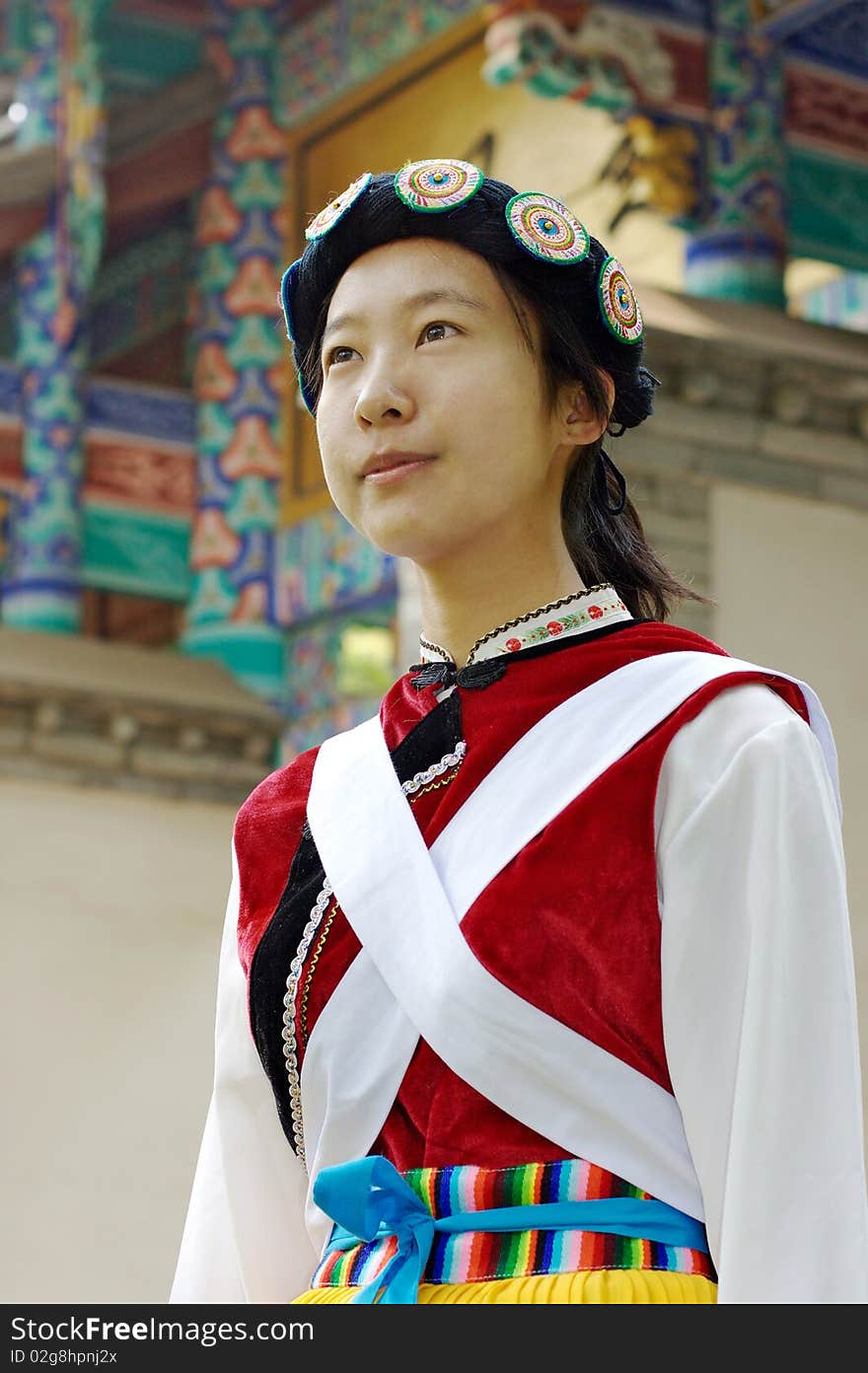 A pretty Chinese woman wearing the traditional clothes of the Naxi cultural minority. A pretty Chinese woman wearing the traditional clothes of the Naxi cultural minority