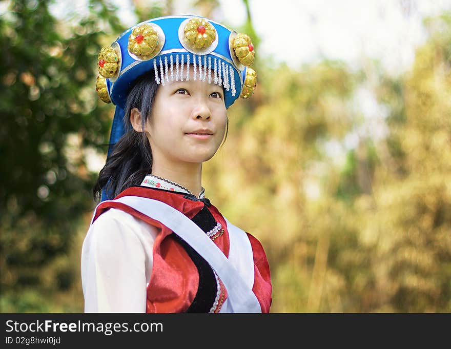 Beautiful Chinese woman dressed in the traditional clothes of the Naxi cultural minority. Beautiful Chinese woman dressed in the traditional clothes of the Naxi cultural minority