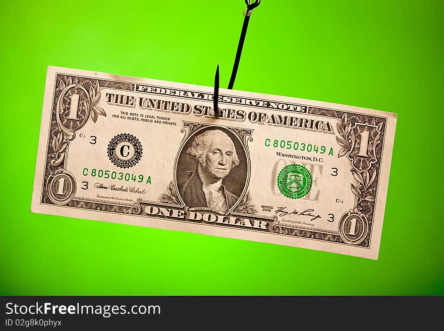 Dollar on hook on green background