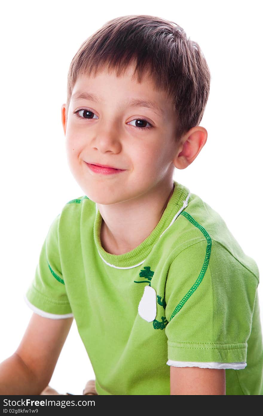 Little smiling boy in green t-shirt studio shot