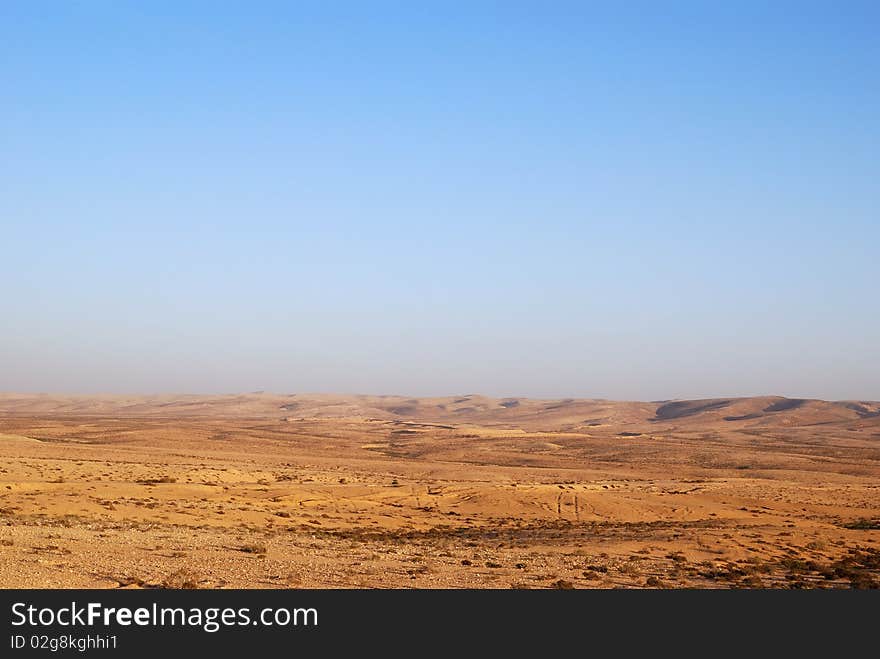 Fragment of Negev desert with mountains on a distance shot. Fragment of Negev desert with mountains on a distance shot