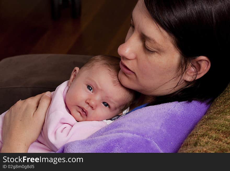 Mum giving her newborn baby a cuddle. Mum giving her newborn baby a cuddle