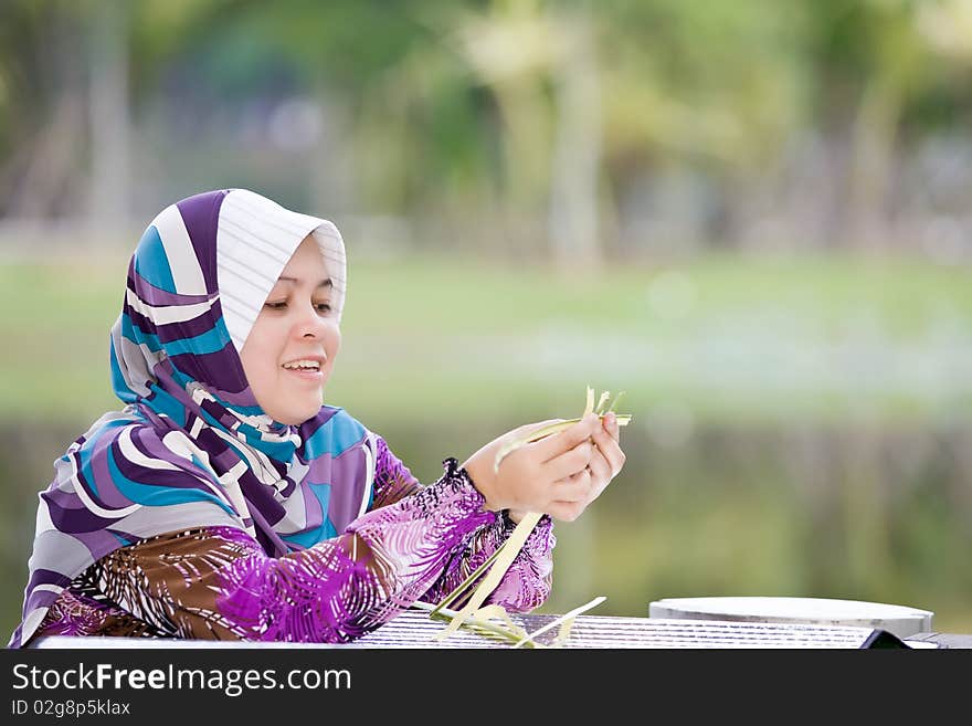 A Woman Weaving Bamboo Mats