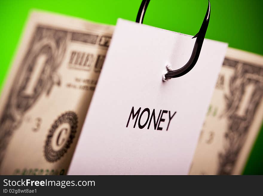 Piece of paper and dollar pierced on hook on colored background. Piece of paper and dollar pierced on hook on colored background