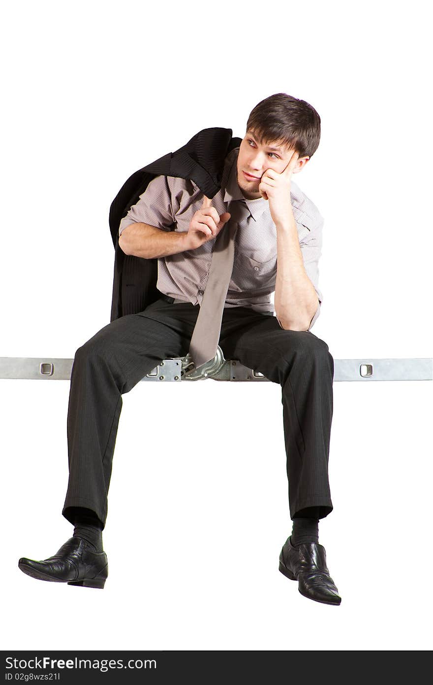 A handsome young businessman with jacket over the shoulder, rolled-up sleeves sitting high on ladder and thinking. Vertical shot. Isolated on white. A handsome young businessman with jacket over the shoulder, rolled-up sleeves sitting high on ladder and thinking. Vertical shot. Isolated on white.