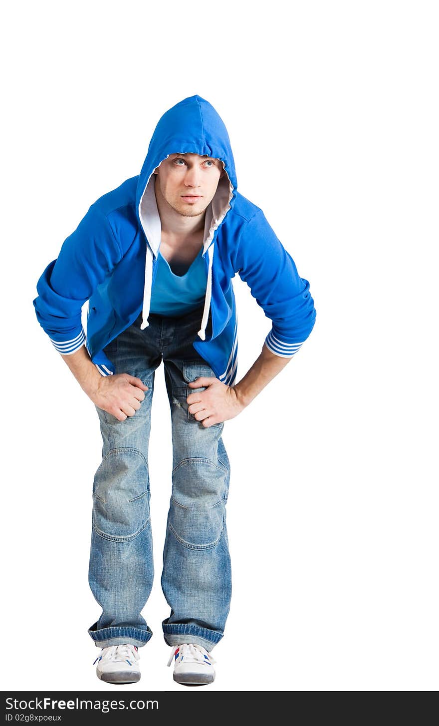 A handsome young man dressed in blue casual clothing with hood on looking up. Vertical shot. Isolated on white. A handsome young man dressed in blue casual clothing with hood on looking up. Vertical shot. Isolated on white.