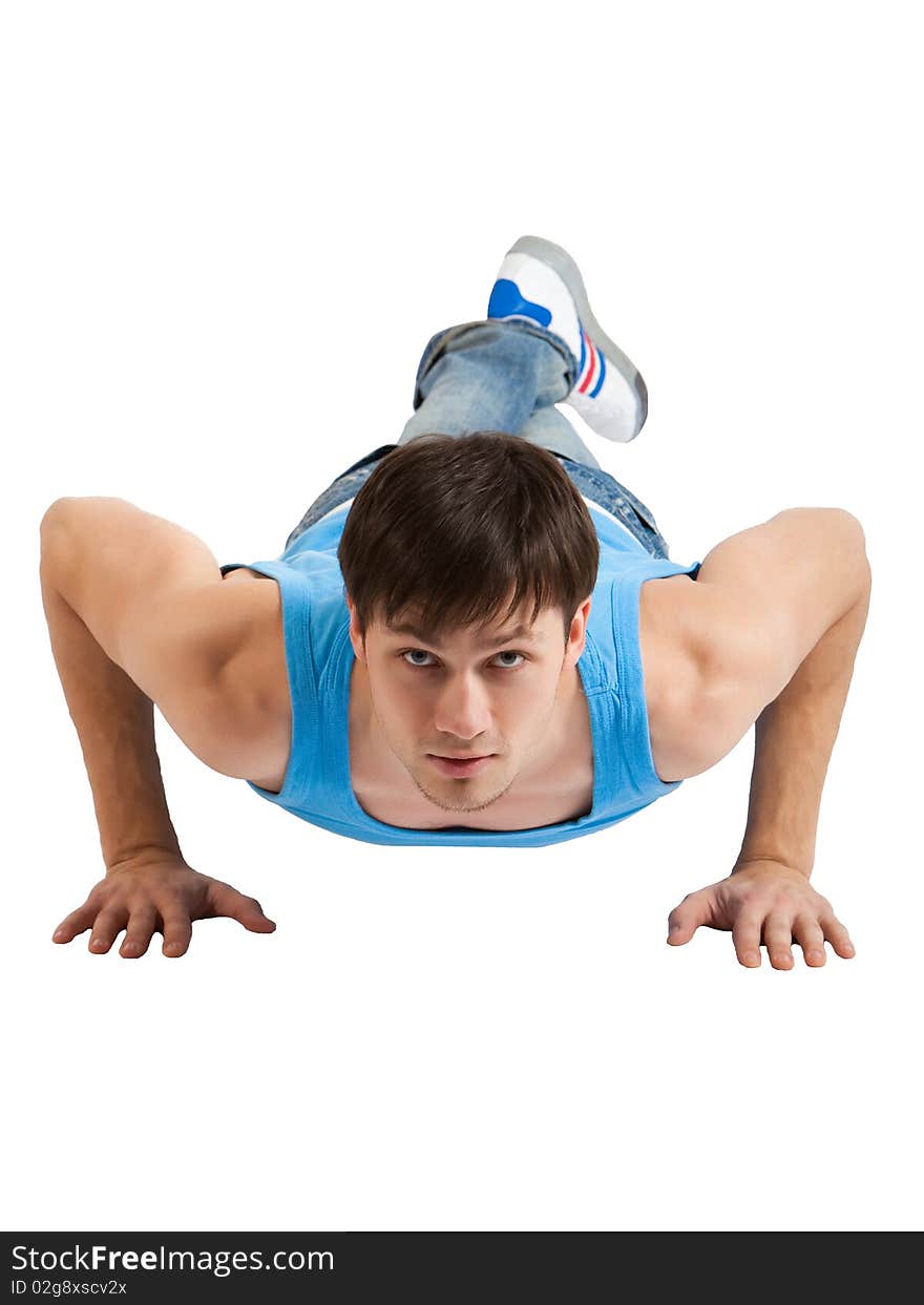 A handsome young man dressed in blue casual clothing making push-ups. Vertical shot. Isolated on white. A handsome young man dressed in blue casual clothing making push-ups. Vertical shot. Isolated on white.