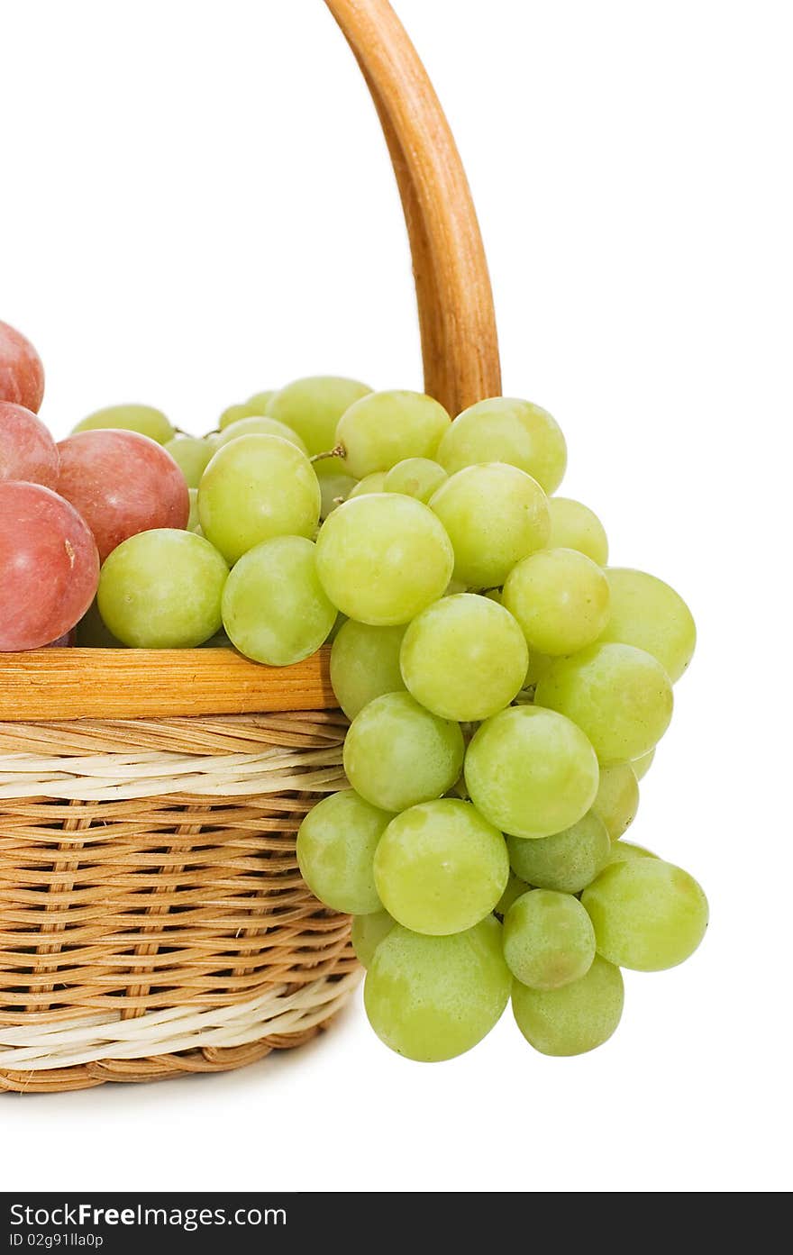 Wattled basket with grapes isolated on white