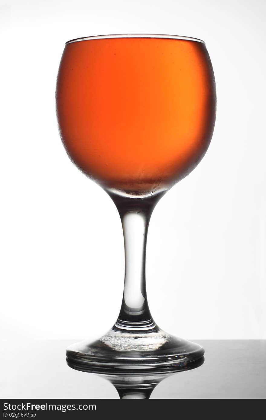 A wine glass with wine in a studio