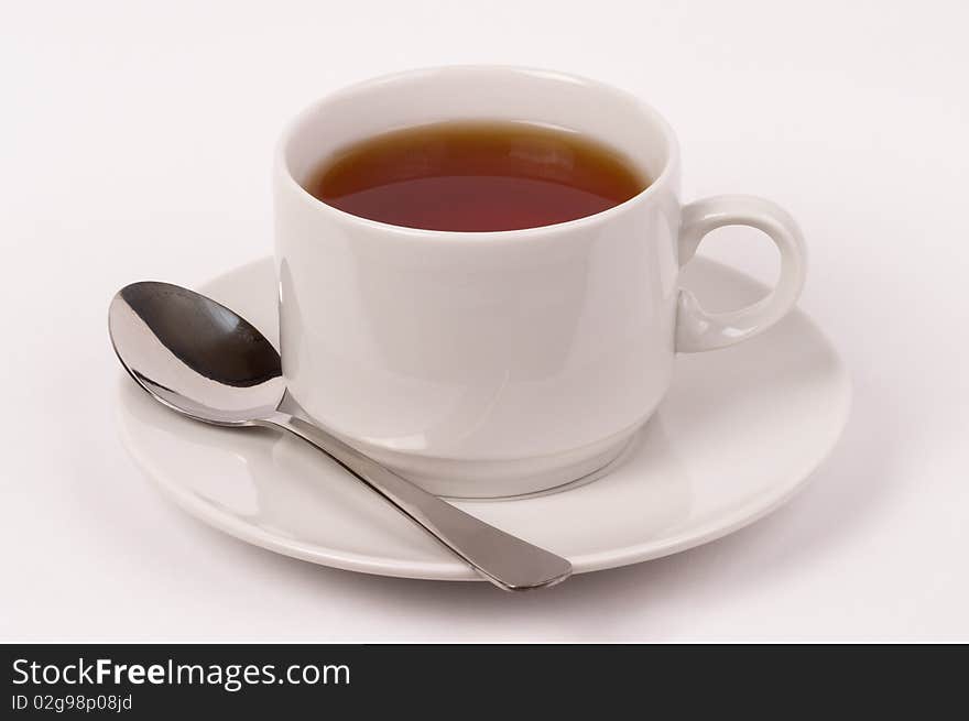 Little white tea cup isolated over grey gradient background