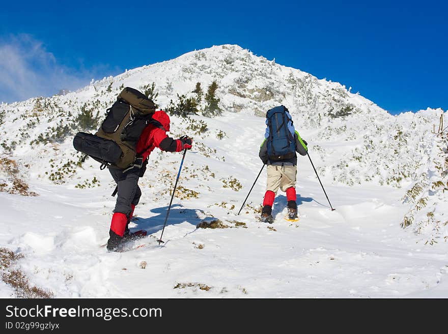 Hiker in winter in mountains