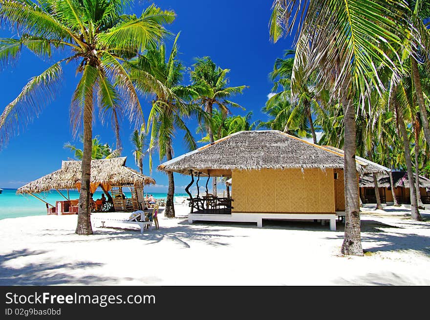 Pictorial tropical scene with native bungalows. Pictorial tropical scene with native bungalows