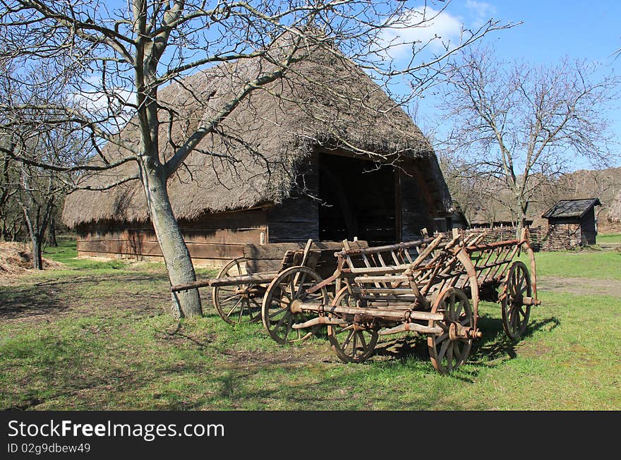 Farm carts in front of the barn.