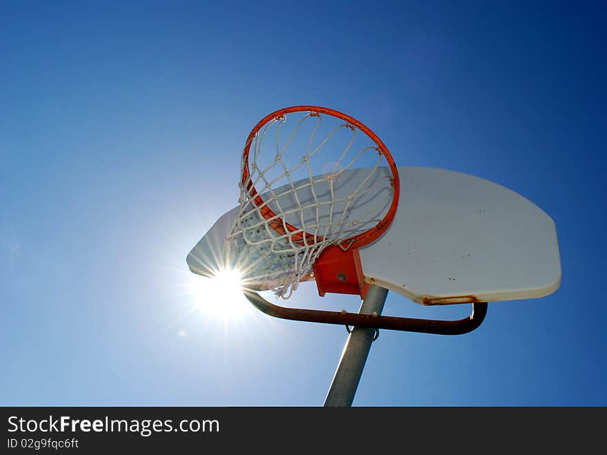 Basketball hoop with blue sky in the background