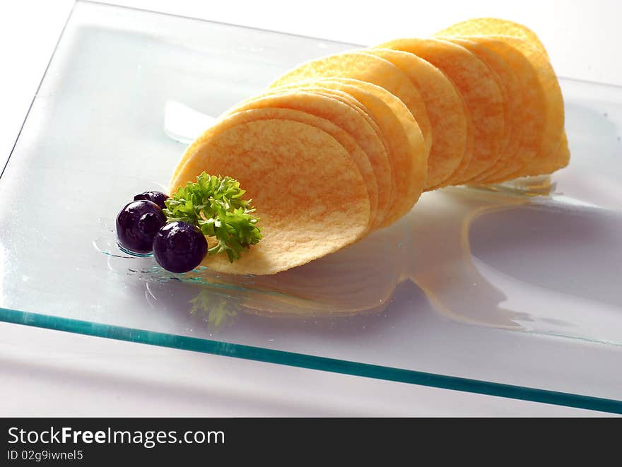 A potato chips on the mirror plate background