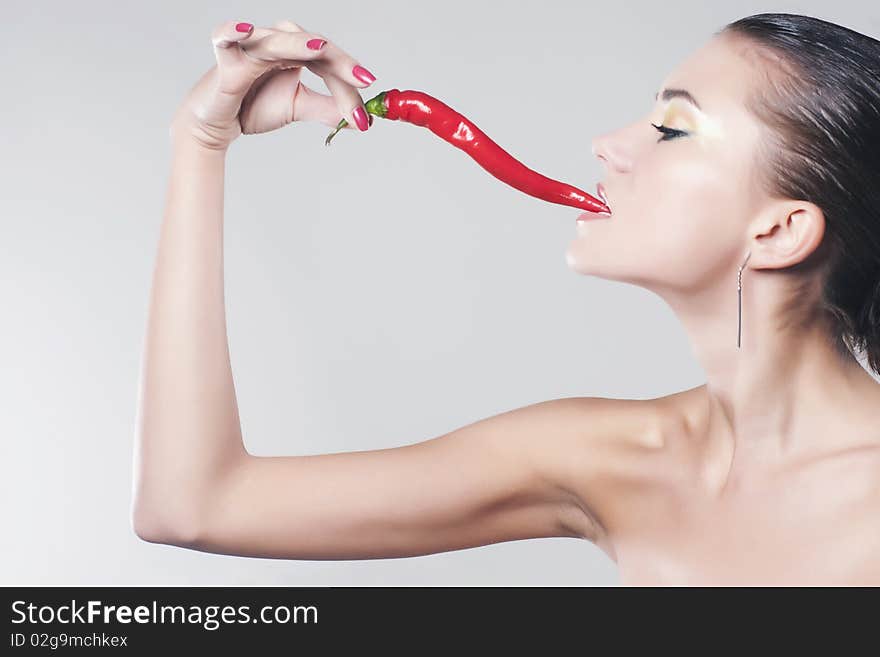 Girl eat hot chili pepper. Girl eat hot chili pepper