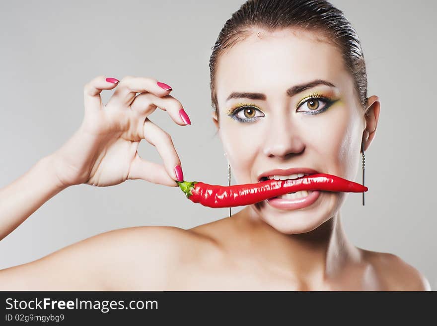 Girl eat hot chili pepper