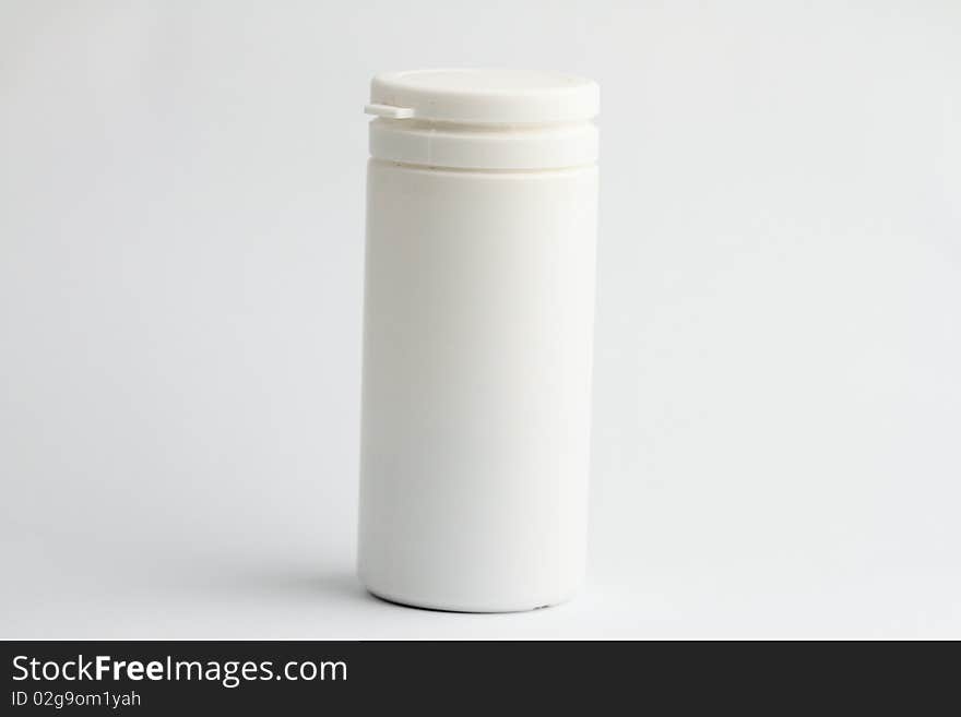 White pill bottle without label on white background.