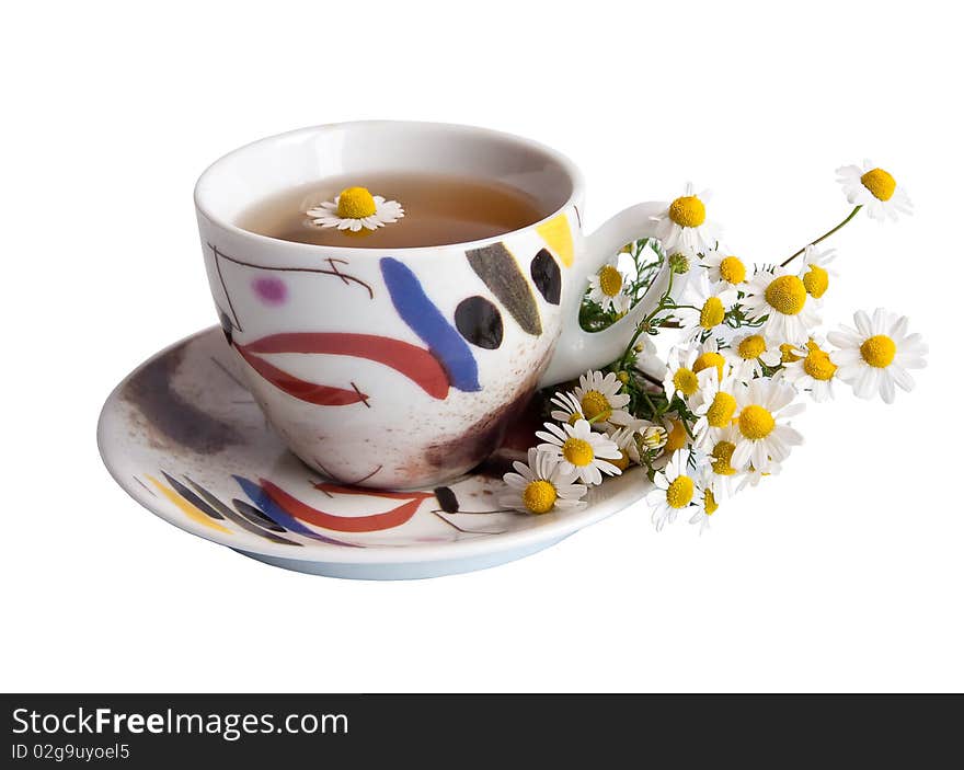 A cup of Chamomile tea with a bouquet of daisies on white. Isolated. A cup of Chamomile tea with a bouquet of daisies on white. Isolated.