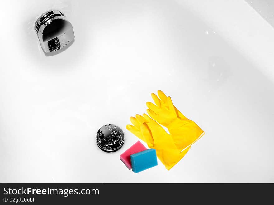 Housework process represented by two sponges pink and blue one that lay down a just cleaned bath near the drain hole. Housework process represented by two sponges pink and blue one that lay down a just cleaned bath near the drain hole