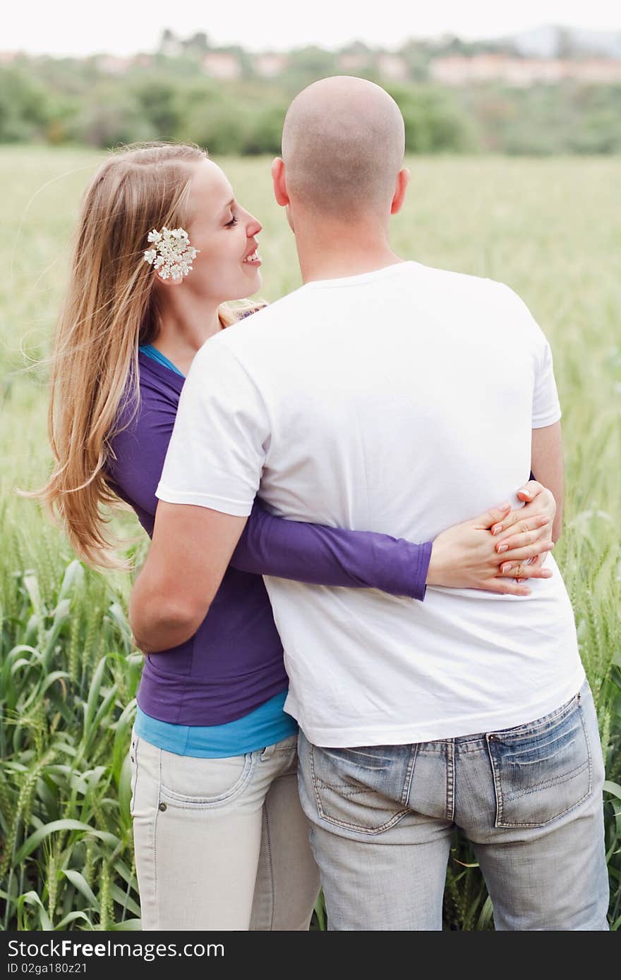 Young romantic couple standing together in the park